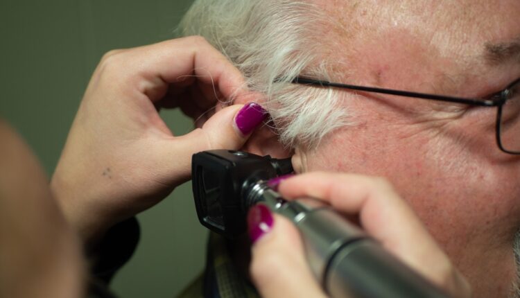 a person holding a phone to the ear
